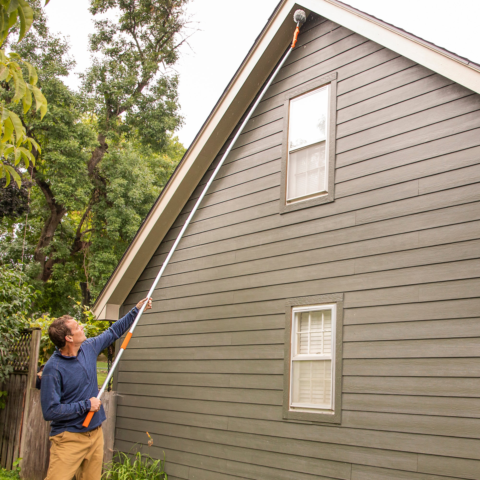 Cobweb duster on 16 ft extension pole cleaning roof overhang.