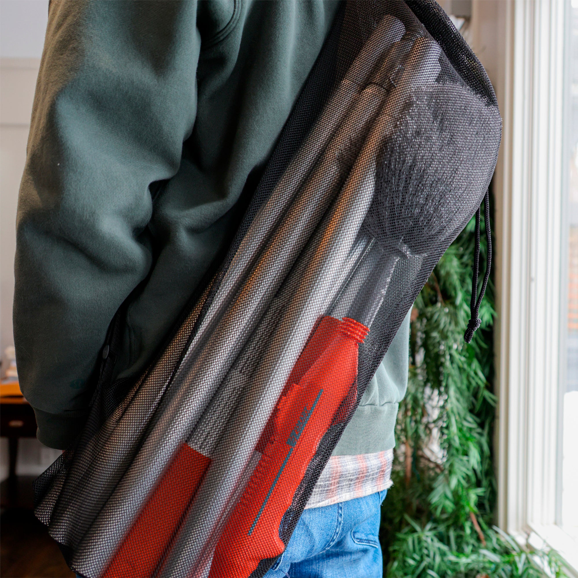 Man with cobweb duster attachment and 16ft extension pole kit packed in mesh storage bag ready for transport