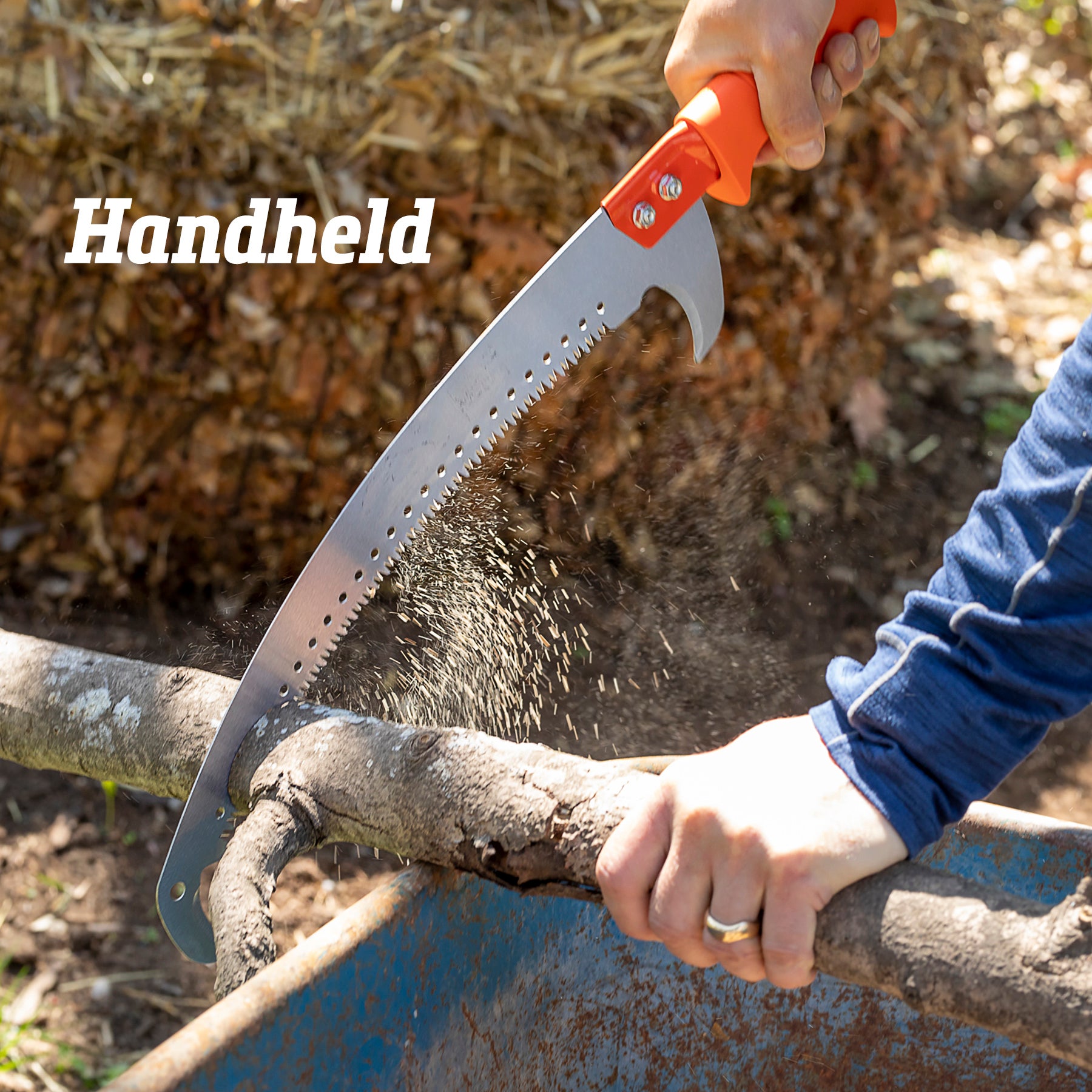 Person using 14-inch pruning saw by hand to cut branch.