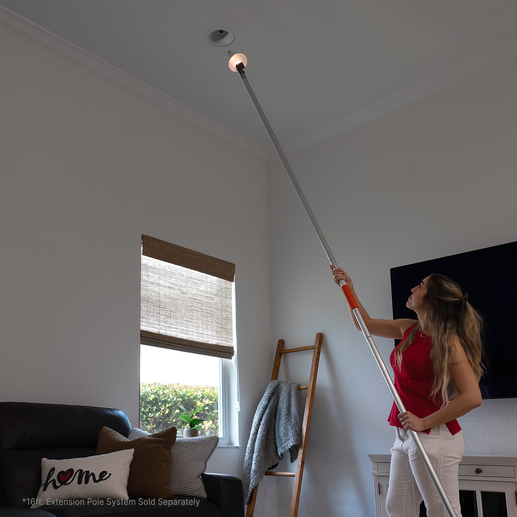 Woman installing a ceiling light fixture with  light-bulb changer with LED light (EZ Smart pole kit sold separately)